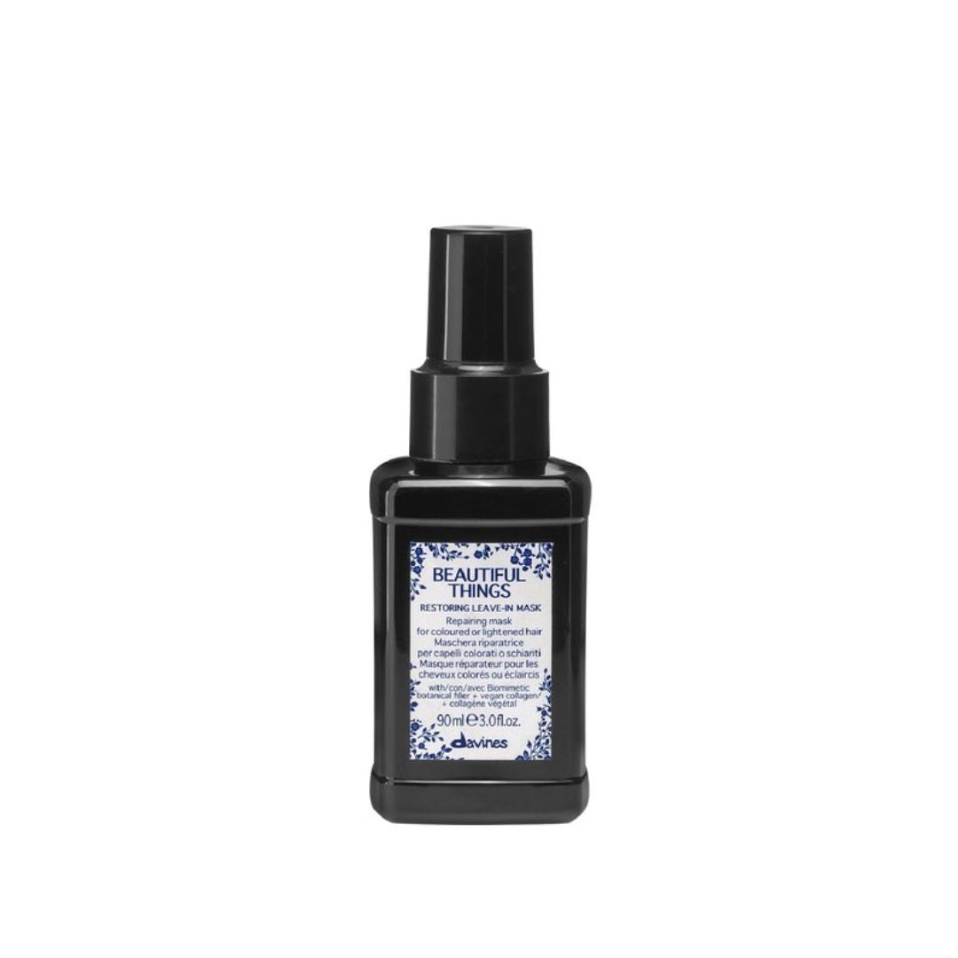 Black bottle of Davines hair product on a white background