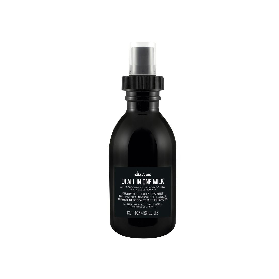 Black bottle of Davines hair product on a white background