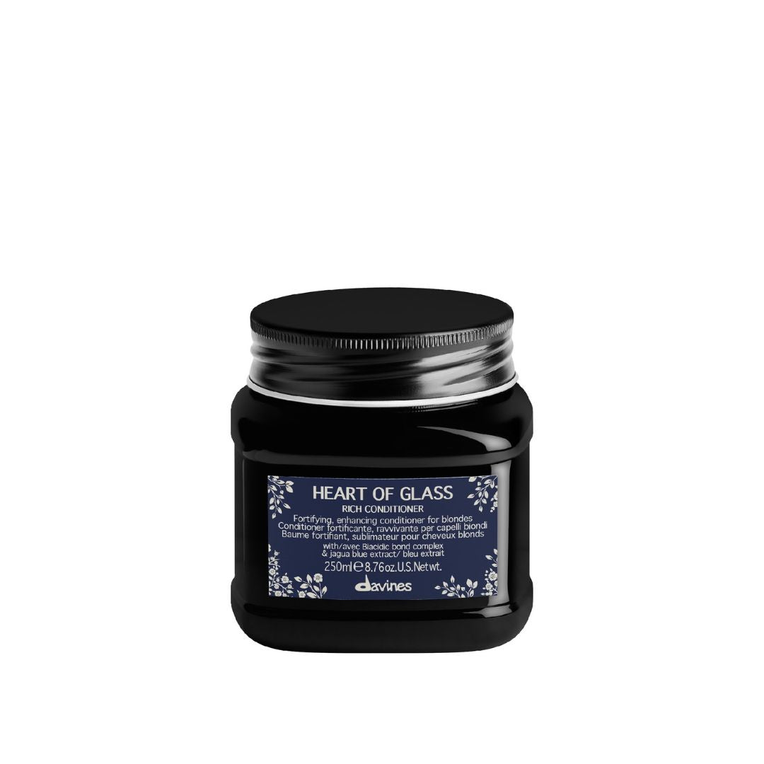 Black hair product jar labeled 'Heart of Glass' on a white background